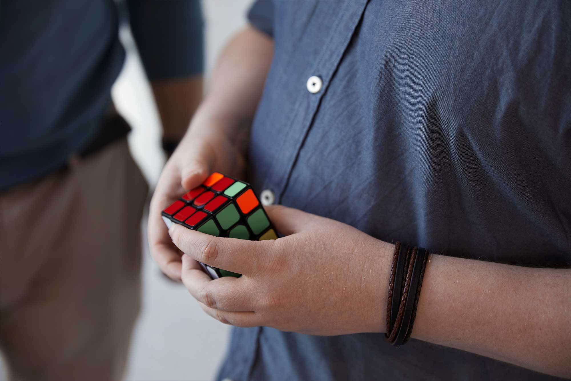 Person playing with rubik's cube
